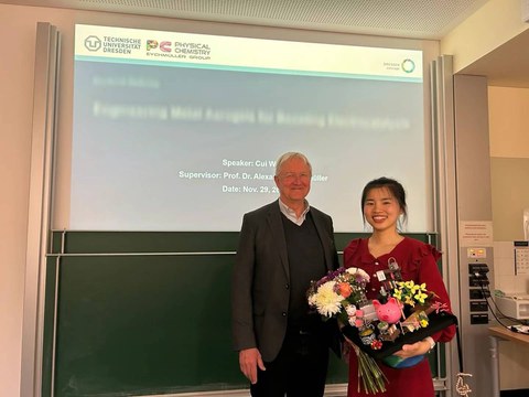 Cui Wang stands next to her supervisor
