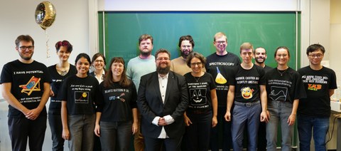 Group in front of a blackboard