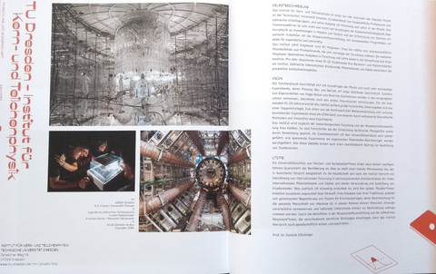 Aufgeschlagenes Buch mit Doppelseite zum Institut für Kern- und Teilchenphysik 