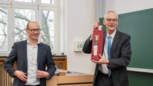 Tüte mit Wein wird übergeben