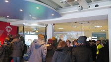 Die Studierenden werfen im Besucherzentrum des ATLAS-Detektors einen Blick in eine Kontrollzentrale.