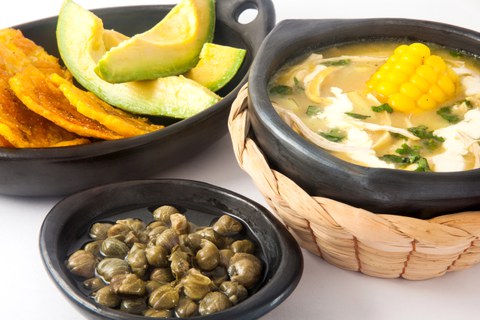 corn soup with sides of avocado and capers