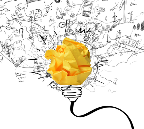 From a light bulb, consisting of crumpled paper, spraying many drawn ideas