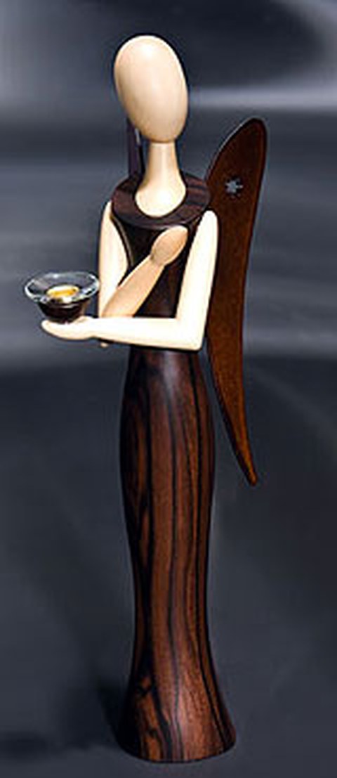 The photo shows an angel made out of wood.