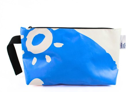 You can see a rectangular cosmetic bag with a zipper on the top. There is a black carrying strap on the left-hand side as a hand loop.