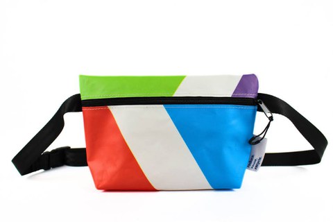 A patterned PVC bag with a long shoulder strap against a light background.The bag has a long adjustable strap and a small TU Dresden logo in the bottom corner.