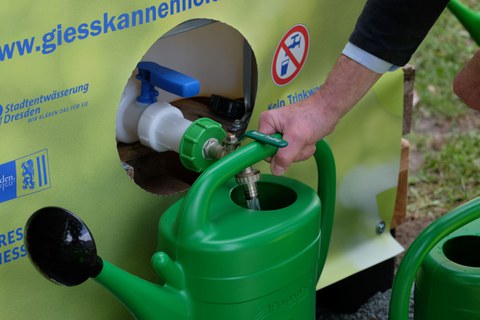 Gießkanne wird mit Wasser gefüllt.