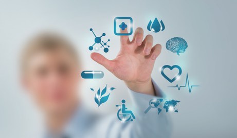Photo shows the hand of a doctor operating a modern computer. Nine medical icons can be seen on the screen.