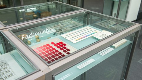Das Foto zeigt eine Vitrine in der eine Darstellung verschiedener Rottöne erkennbar ist.