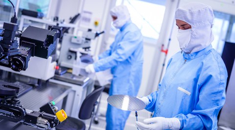 Workers in protective suits in the clean room