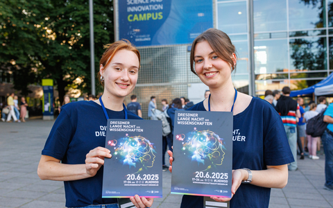 The photo shows two women each holding a program for the 2025 Dresden Science Night