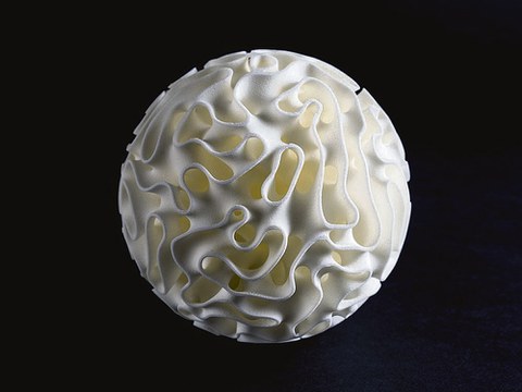 Zu sehen ist eine weiße Kugel. Diese ist an vielen Stellen unterbrochen und löchrig.