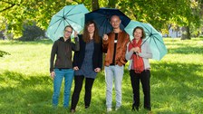 Three Women and one man with blue Umbrellas