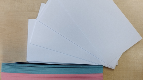 You can see a pile of different colored papers