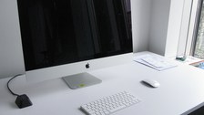 Photo of an iMac 27-inch with keyboard and mouse.