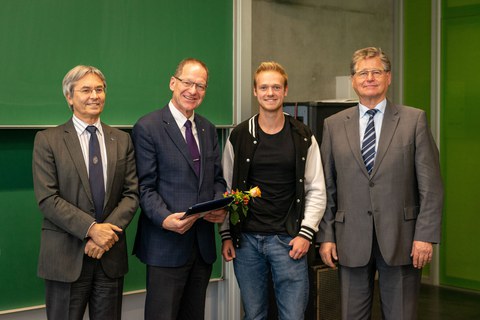 Four men standing in a row.