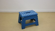 Photo shows a top view of the folding stool.