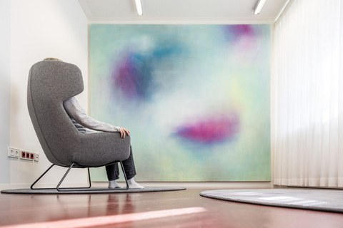 Innenaufnahme Raum der Stille mit großem Wandbild und Ruhesessel
