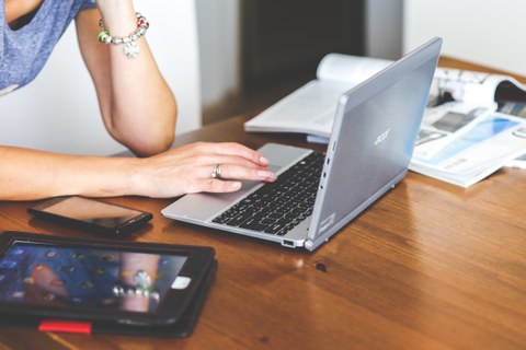 Photo of a person filling out a survey on their tablet.