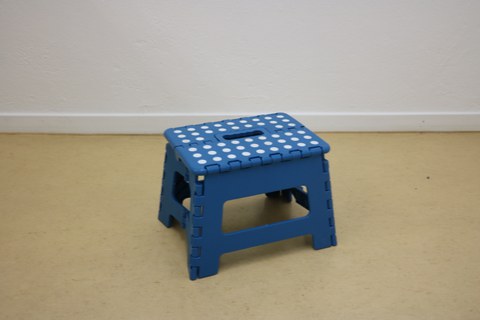 Photo shows a top view of the folding stool.