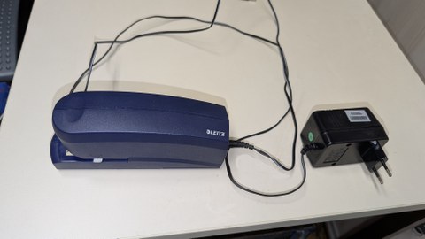 Photo shows the electric stapler on a table