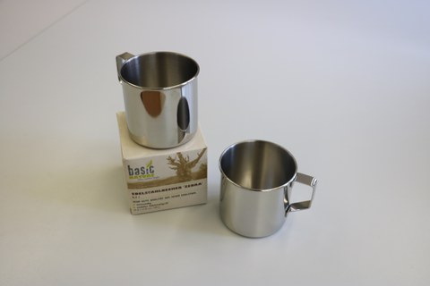 Photo shows the two stainless steel mugs with handle, the mug on the left is on the corresponding box.