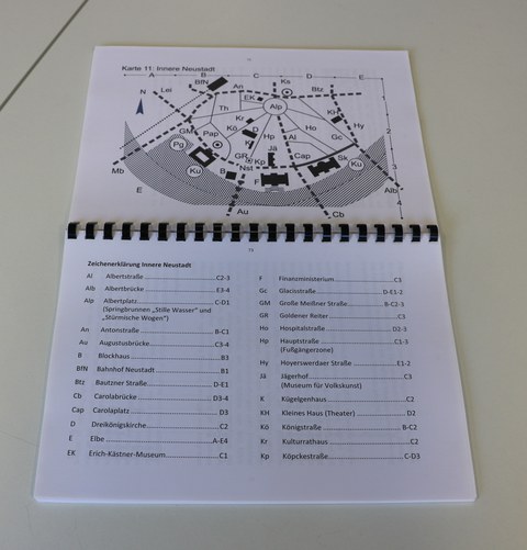 Photo shows the open booklet (ring binding) with maps of various city regions in Dresden. The photo shows Map 11: Innere Neustadt on the top page, on the page below is an overview for an explanation of the signs for Innere Neustadt.