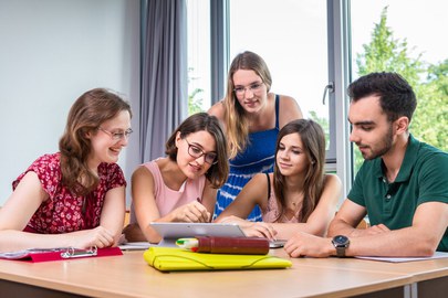 Picture of 5 students working together 