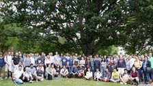 Numerous people pose for a group picture.
