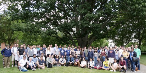 Numerous people pose for a group picture.