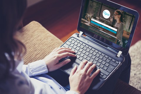 The photo shows a person with a laptop on their lap. On the screen, we can see they have the OPAL website open.