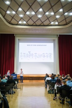 Lia Söder und David Kurz zeigen dem Publikum ihre Präsentation. 