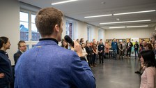 Foto zeigt einen Saal mit einem Mann, der einen Vortrag hält.