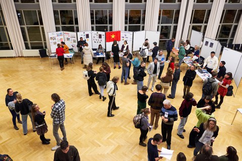 Eine Gruppe von Studierenden informiert sich an Ständen zu Auslandsaufenthalten.