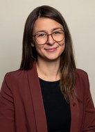 Portrait of a woman with long hair and glasses.