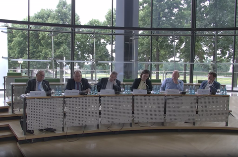 Sechs Personen sitzen nebeneinander an einem Konferenztisch im sächsischen Landtag.